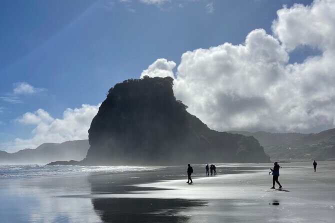 Piha Beach - Black-sand beach time: surf, cliffs, and low-tide treasure hunting