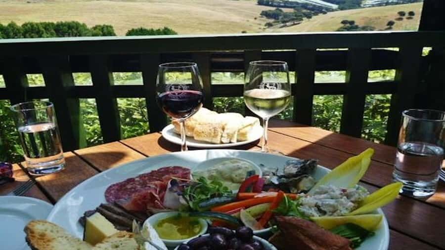 Waiheke: Scenic Taste and Graze Tour with Wine, Whisky, Beer - Mudbrick Restaurant and Vineyard: wine tasting with Rangitoto in your line of sight